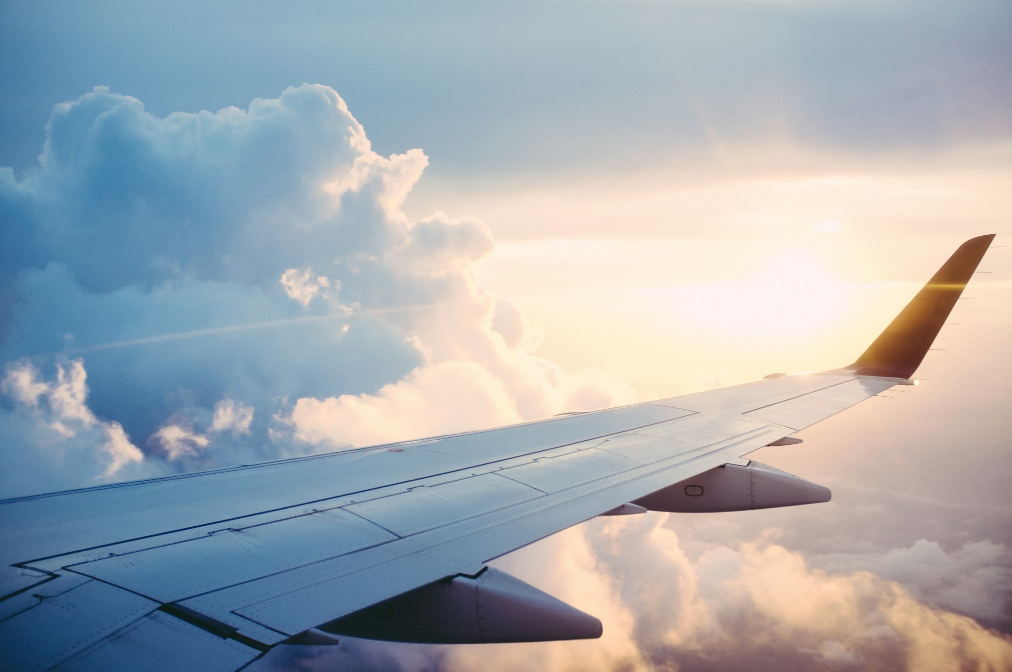 Aerial photography of an airliner banking above the clouds